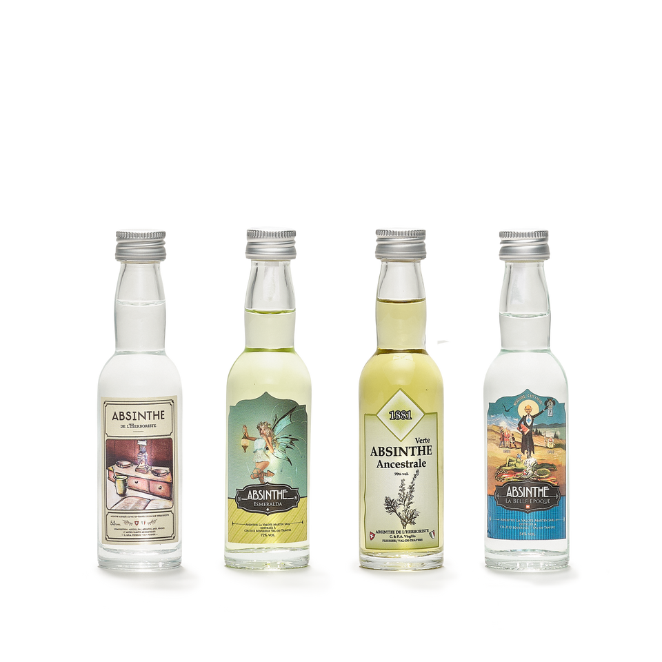 Four small tasting bottles standing side by side, each with a silver screw cap and a different illustrated label.