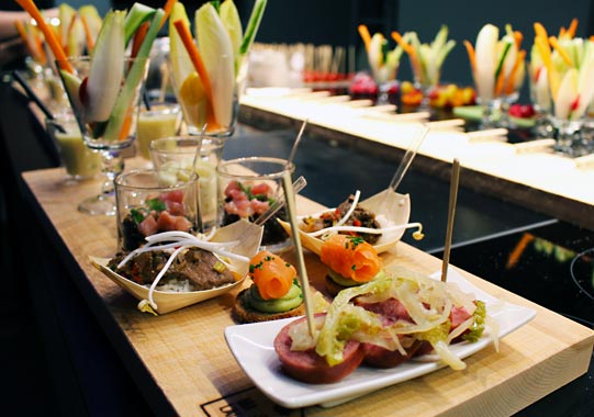 A buffet of canapes and vegetable glasses laid out on the museum bar for an afterwork evening