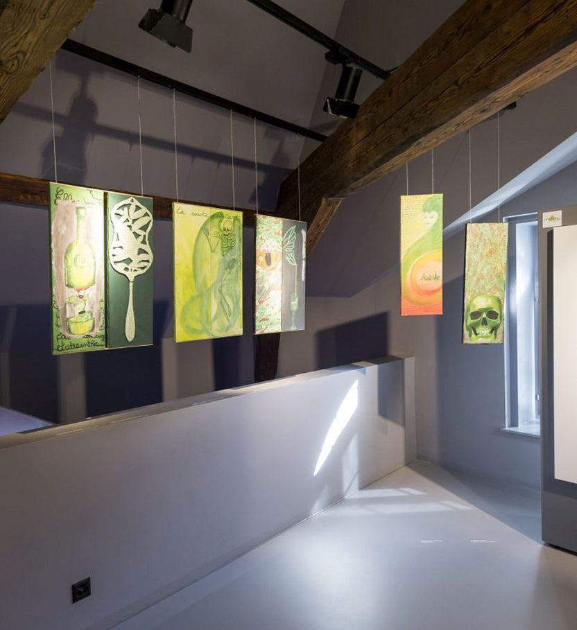 A gallery view of paintings from the Absinthe sur toiles exhibition