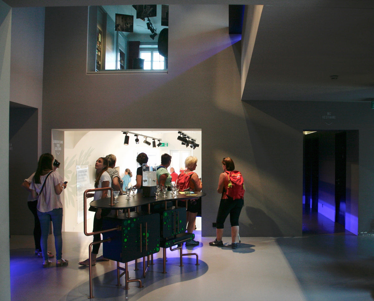 Group of visitors at the Maison de l'Absinthe main entrance, Belle Époque facade