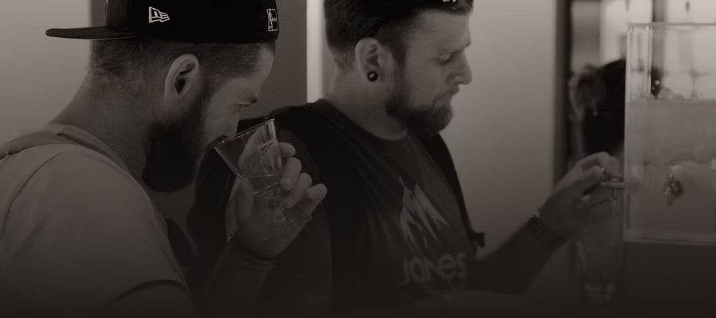 Two visitors tasting absinthe at the bar