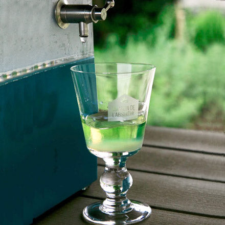 A glass filled at an absinthe fountain during the Balade gourmande du Val-de-Travers